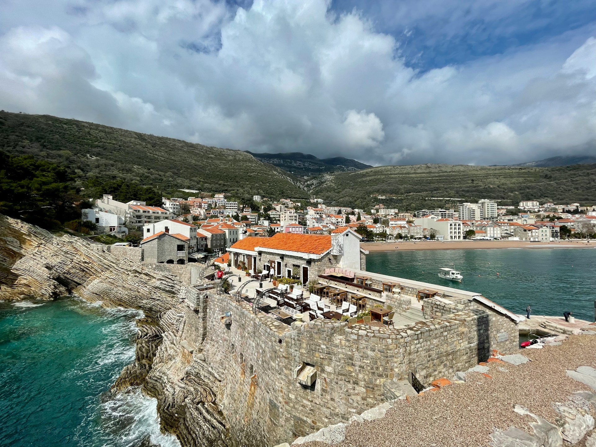Kaštel Lastva fortress overlooking the bay and town beach at Petrovac, Montenegro