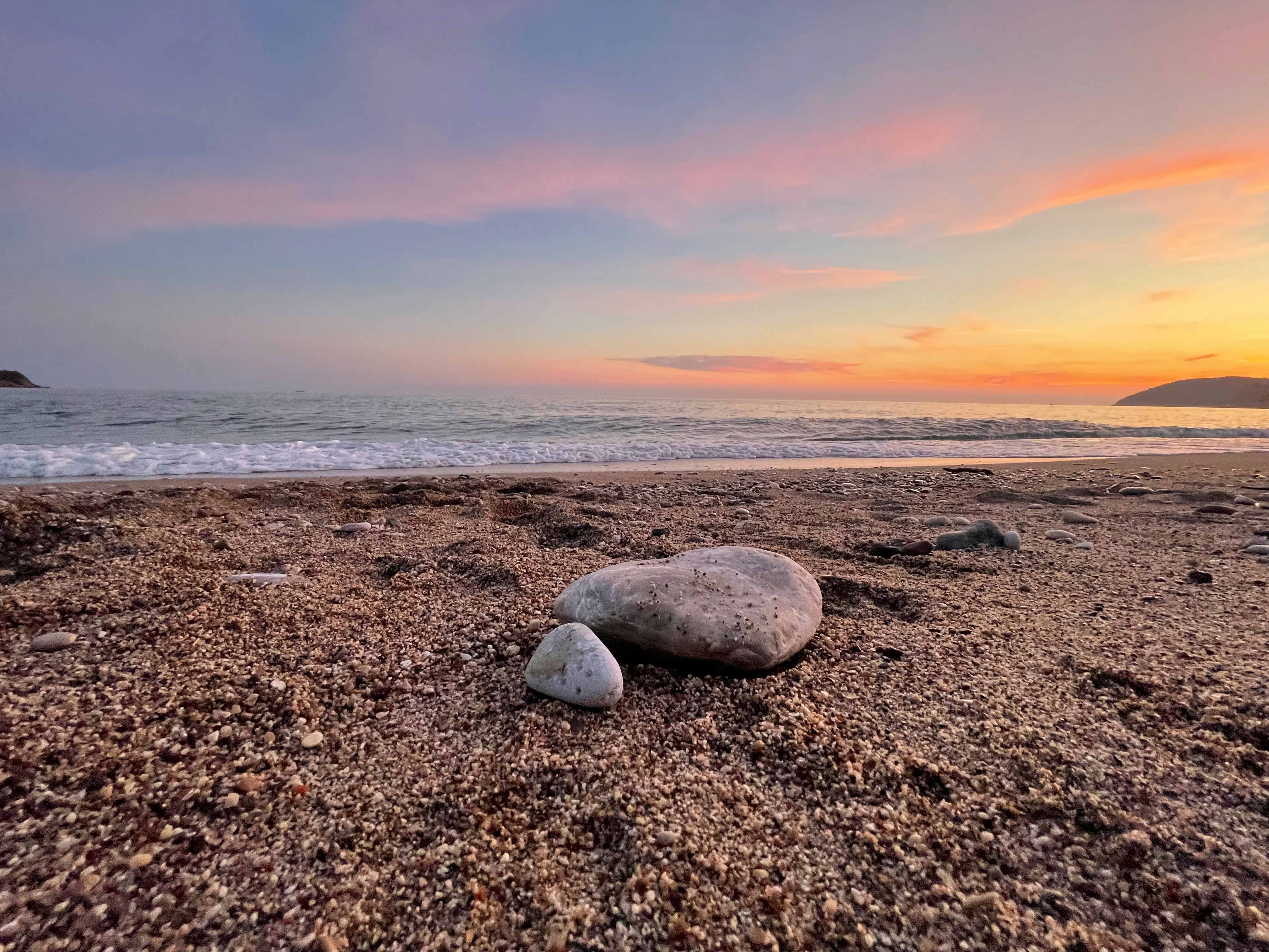 Rocks on the sandy shore at Sutomore, Montenegro, with calm sea beyond