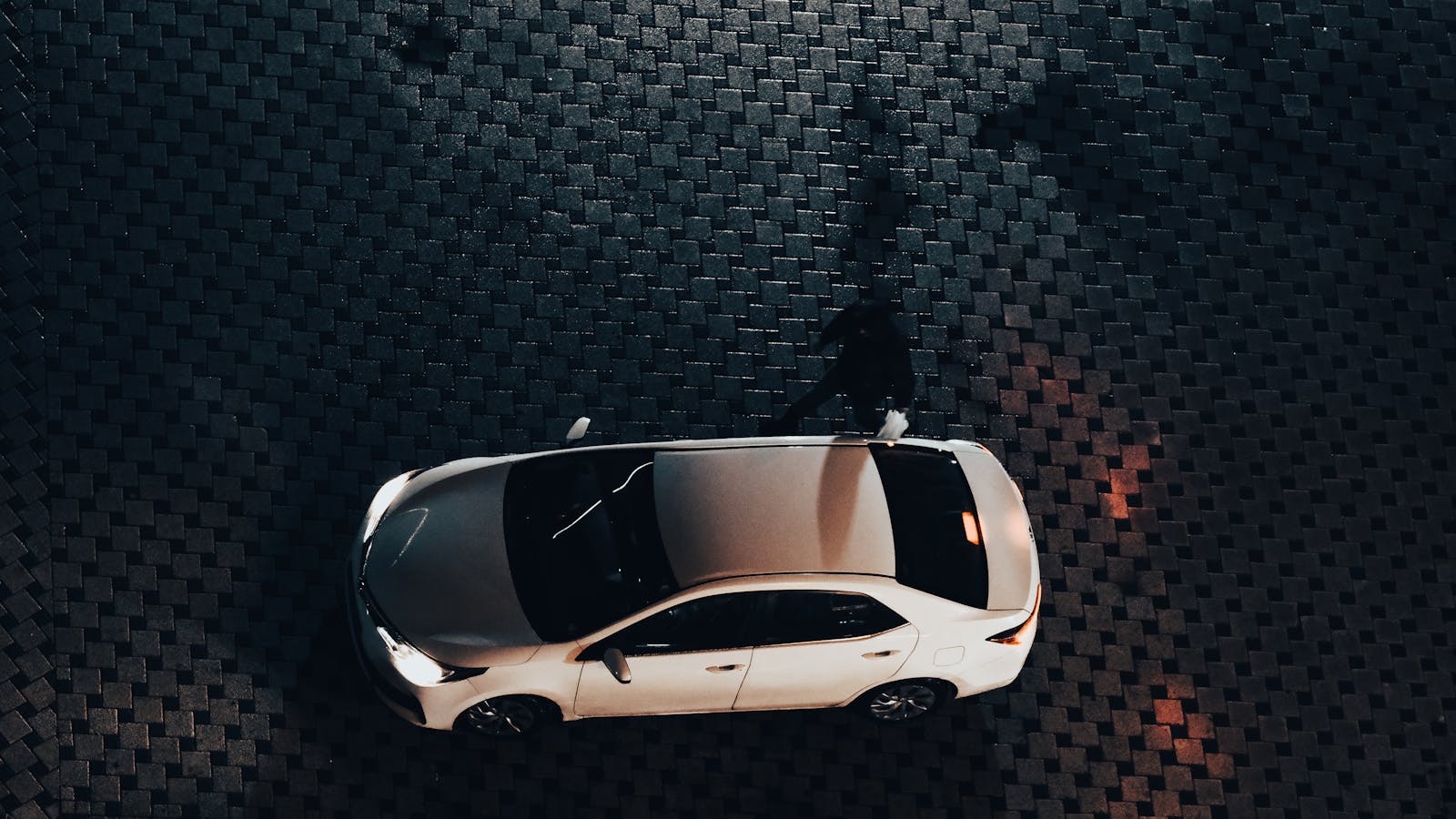 Aerial view of a white rental car at night